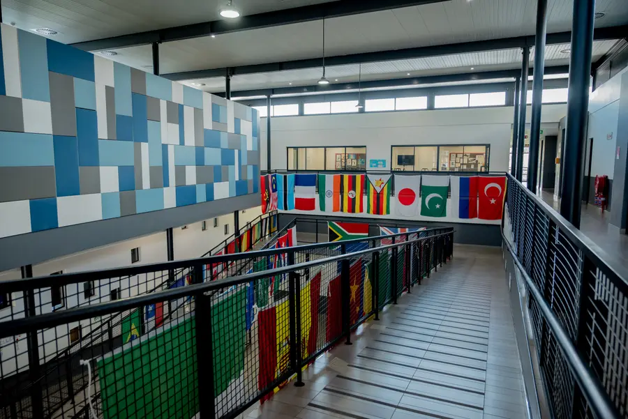 The double-volume walkway hung with flags, with blue tiled walls